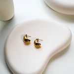 The Amaya Earrings on a white dish