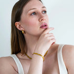 A woman wearing the 18k gold plated Selene bracelet 